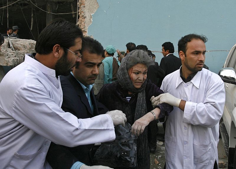 Afghan doctors help an injured woman after a suicide attack in Kabul