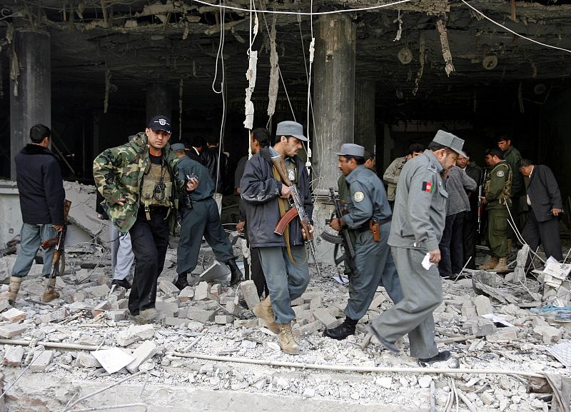 Afghan policemen secure the area after a suicide attack in Kabul