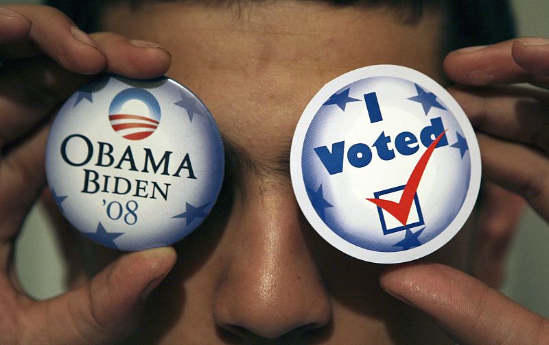 A Jordanian poses with campaign badges of Democratic presidential nominee Senator Barack Obama during an election night in Amman