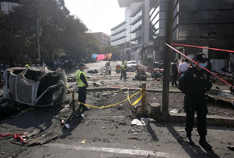 Policemen officer guard at the site of a plane crash in Mexico City