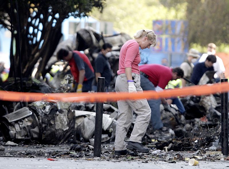 Mexican workers and foreigns experts work at the scene of a plane crash in Mexico City