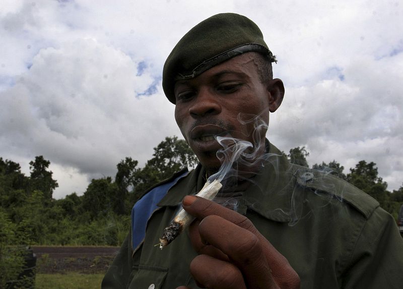 A soldier of the Congolese army (FARDC) smokes marijuana on the frontline in Kibati