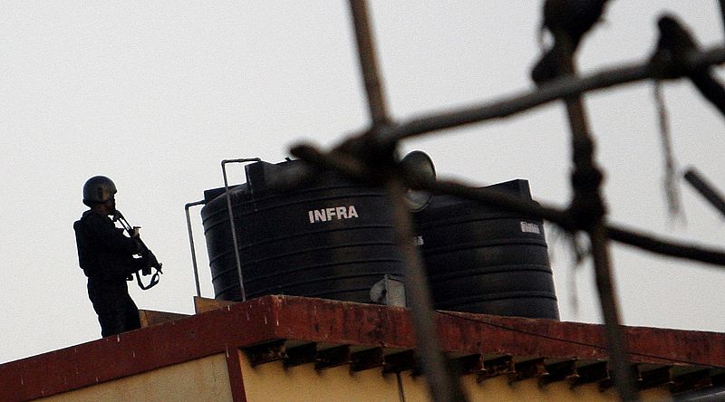 An Indian commando takes position in the neighbouring building of "Nariman Bhavan", where armed militants are believed to be holed up in Mumbai