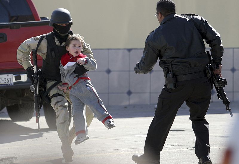 Un policía cargando con un niño durante un tiroteo en Tijuana, en el estado mexicano de Baja California