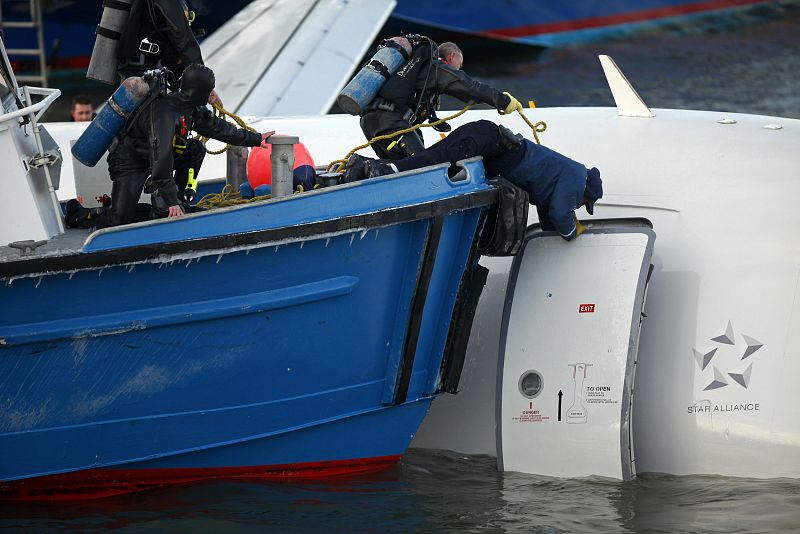 Emergency personnel search for more passengers after a U.S. Airways plane landed in the Hudson River in New York