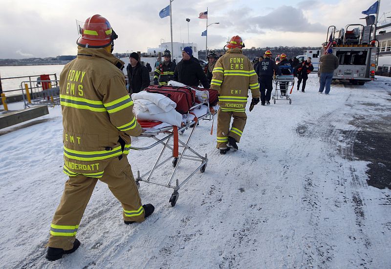 Rescue workers arrive near the scene of a  U.S. Airways plane crash in the Hudson River in New York