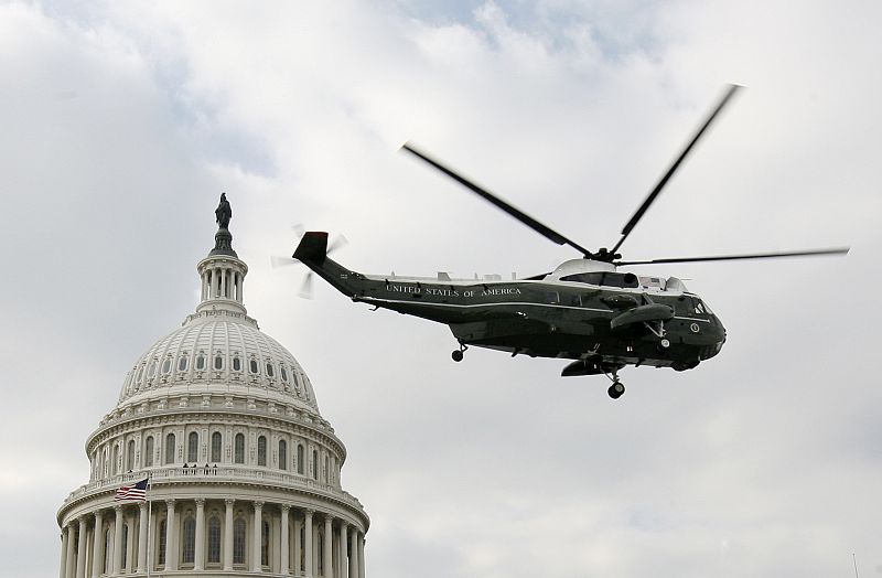 The helicopter carrying former U.S. President George W. Bush flies past U.S. Capitol dome following the inauguration of President Barack Obama in Washington