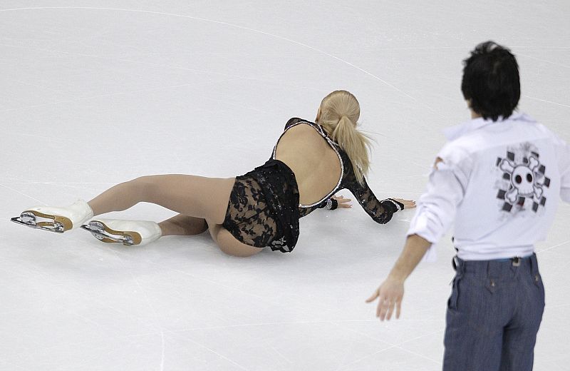 Mukhortova of Russia falls next to her partner Trankov during the pairs free program at the European Figure Skating Championships in Helsinki