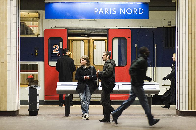 Commuters wait for a train at Gare du Nord train station in Paris