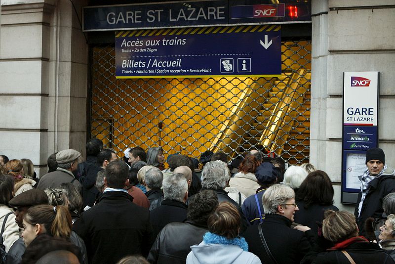 Commuters wait for the opening of the Gare Saint Lazare train station in Paris