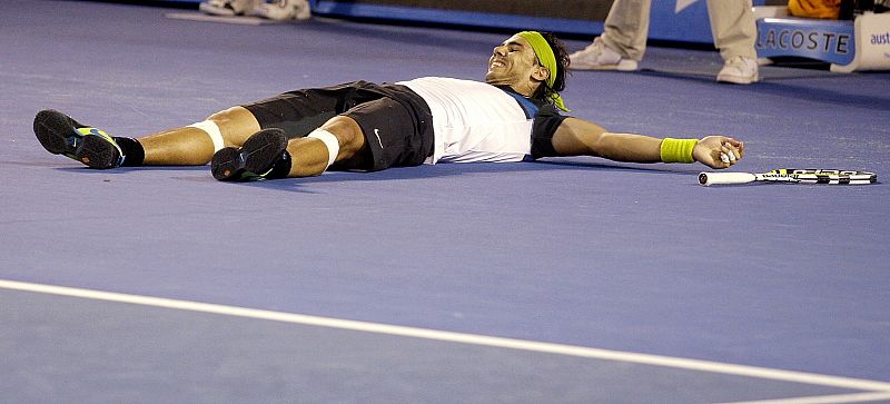 Spain's Nadal celebrates winning his men's singles final match against Switzerland's Federer at the Australian Open