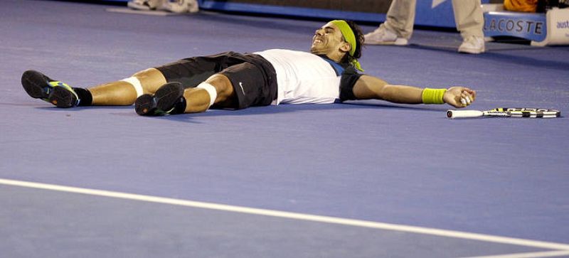 Spain's Nadal celebrates winning his men's singles final match against Switzerland's Federer at the Australian Open 
