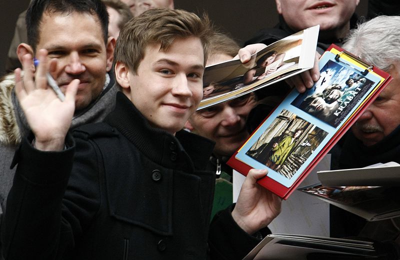 Actor David Kross signs autographs as the arrive to address a news conference to promote the movie 'The Reader' of the 59th Berlinale film festival in Berlin