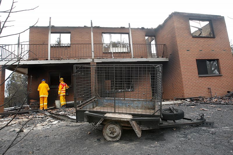 The remains of a house and cabins destroyed by bushfires are seen in the town of Wandong