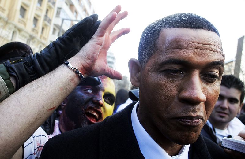 Men dressed as Zombies try to scare a U.S. president Barack Obama look-alike during a Zombie gathering in Madrid