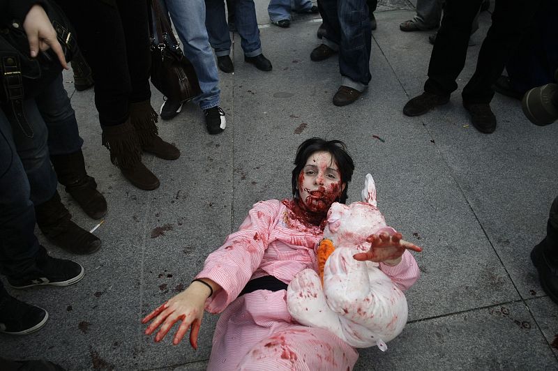 A woman dressed like a zombie performs during a zombie gathering in Madrid