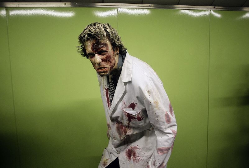 A man dressed like a zombie enters a subway station in Madrid