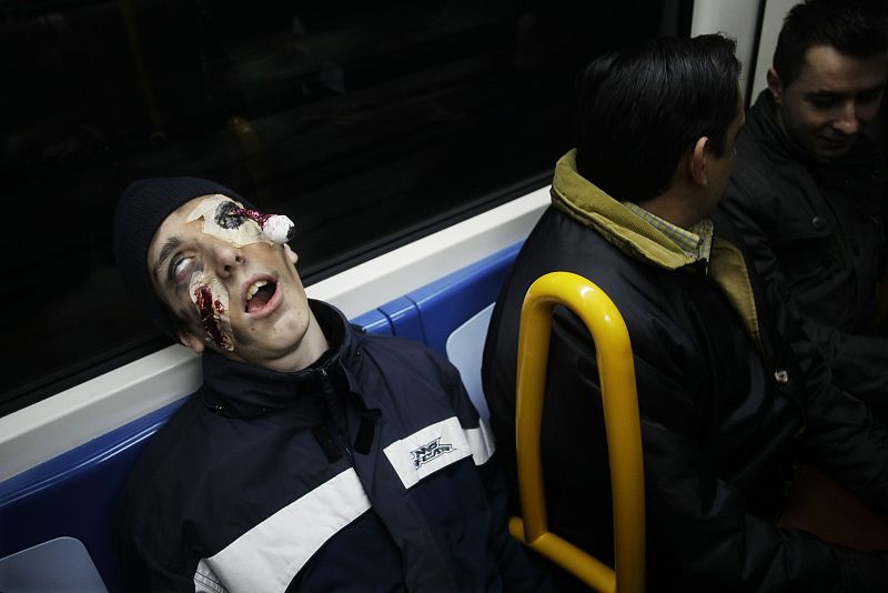 A man dressed like a Zombie rides the subway in Madrid