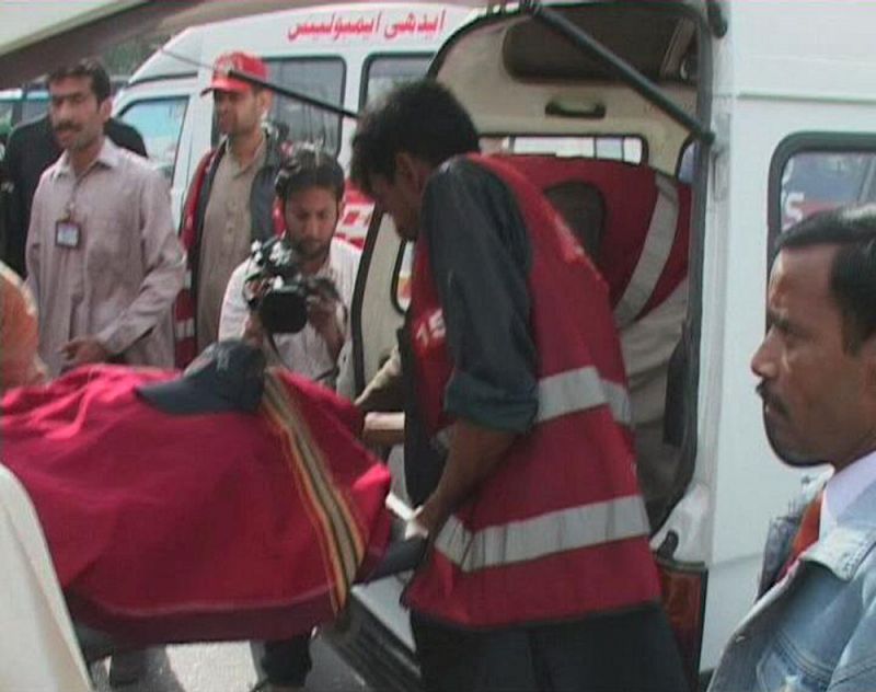 A video grab shows a body being put into an ambulance after an attack by gunmen in Lahore