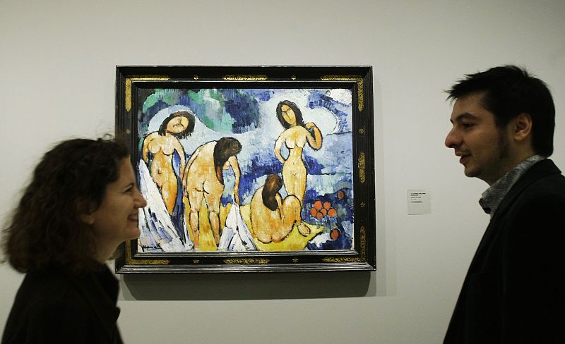 People talk next to painting during media presentation of exhibition "Maurice de Vlaminck, a Fauve Instinct" at Madrid's Caixa Forum