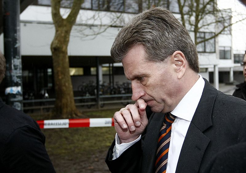 Baden-Wuerttemberg's state prime minister Guenther Oettinger reacts as he walks outside a school where a shooting incident took place in Winnenden