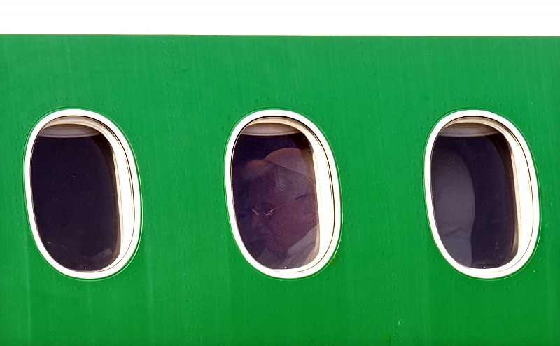 Pope Benedict XVI sits aboard an airplane departing for Africa at Fiumicino international airport in Rome