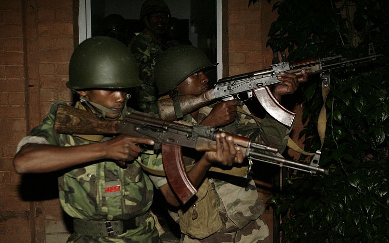 Soldiers take aim after two tanks backed by troops forced their way into a presidential palace in Antananarivo