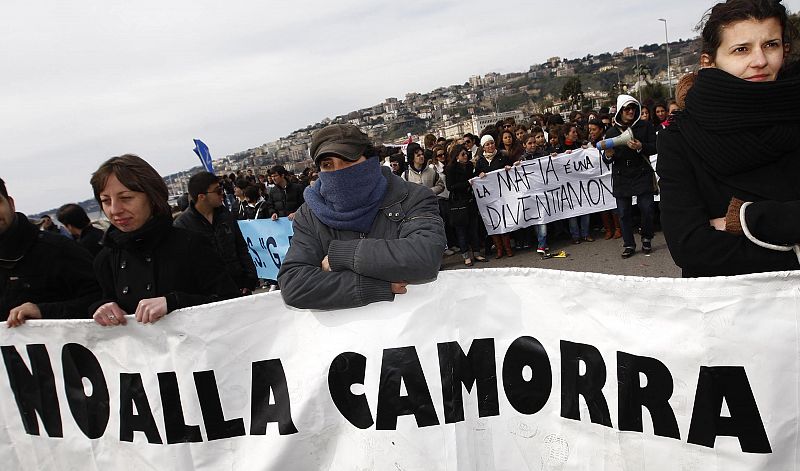 Demonstrators hold a banner reading "No to the Camorra" as they march in the southern city of Naples