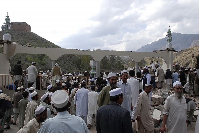 Pakistani tribesmen at the site of suicide blast near Jamrud in the Khyber agency tribal region