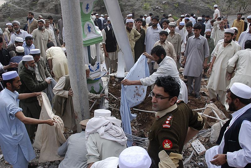 Pakistani tribesmen gather as they take part in rescue work at the site of a suicide blast near Jamrud in the Khyber agency tribal region