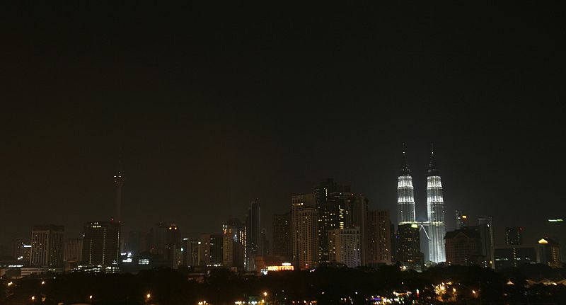 A view of Kuala Lumpur skyline at the beginning of Earth Hour when a part of the lights of Petronas Towers are switched off