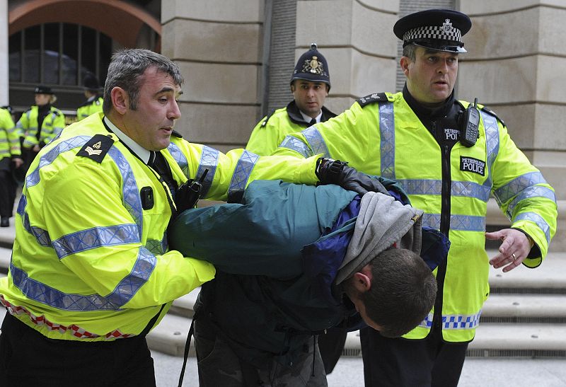 La policía arresta a un manifestante cerca de la entrada de la Bolsa de Londres.