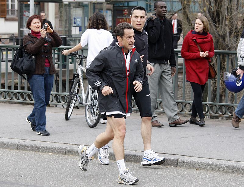 France's President Sarkozy jogs after meeting US President Obama in Strasbourg