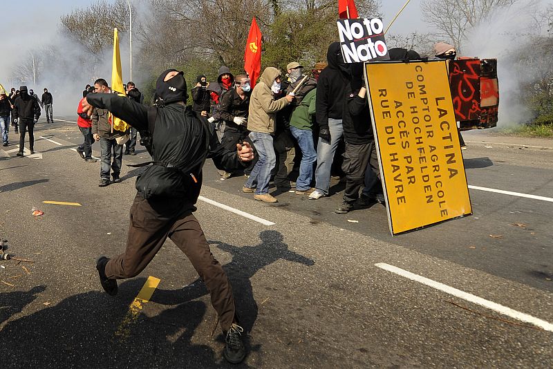 Anti-NATO protestors throw stones at French police during a rally against the NATO summit in Strasbourg