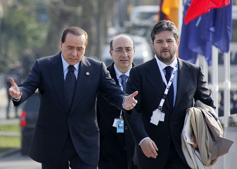 Italy's Prime Minister Silvio Berlusconi gestures as he arrives at the "Two Banks Bridge" on the Rhine river in Kehl