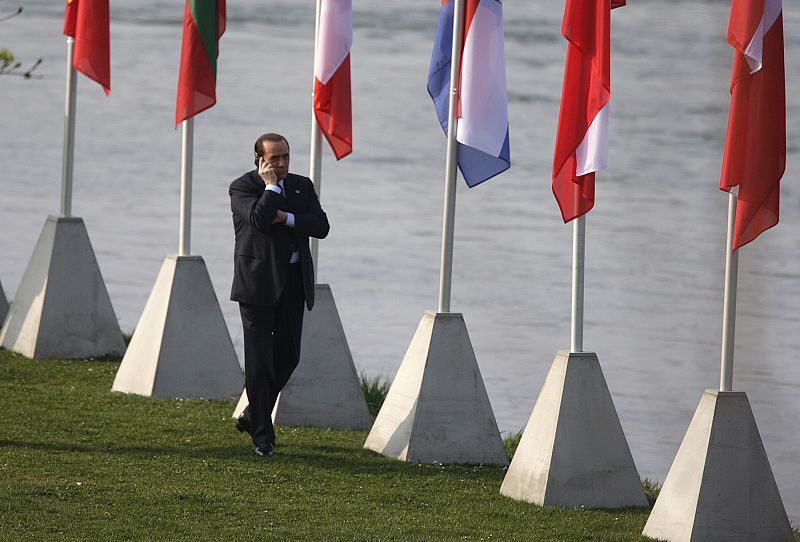 Prime Minister Berlusconi talks on his mobile phone as he arrives at the "Two Banks Bridge" on the Rhine river in Kehl