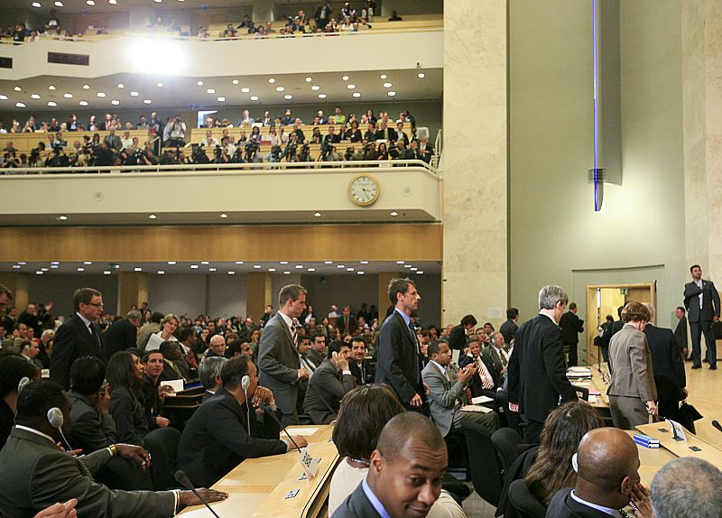 Unidentified delegates walk out of the Assembly Hall as Iran's President Ahmadinejad addresses the High Level segment of the Durban Review Conference on racism at the United Nations European headquarters in Geneva