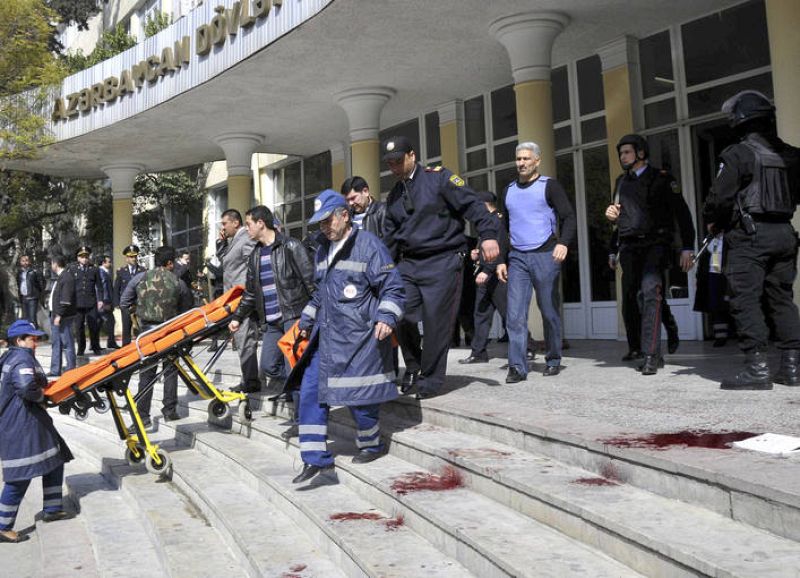Emergency and Interior Ministry specialists are seen at the main entrance into a university in Baku
