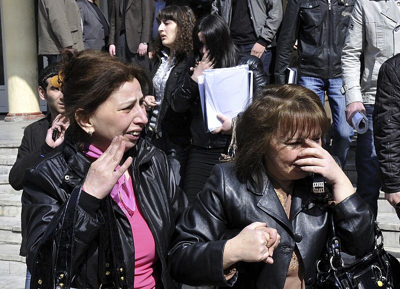 Professors and students react after a shooting at a university in Baku