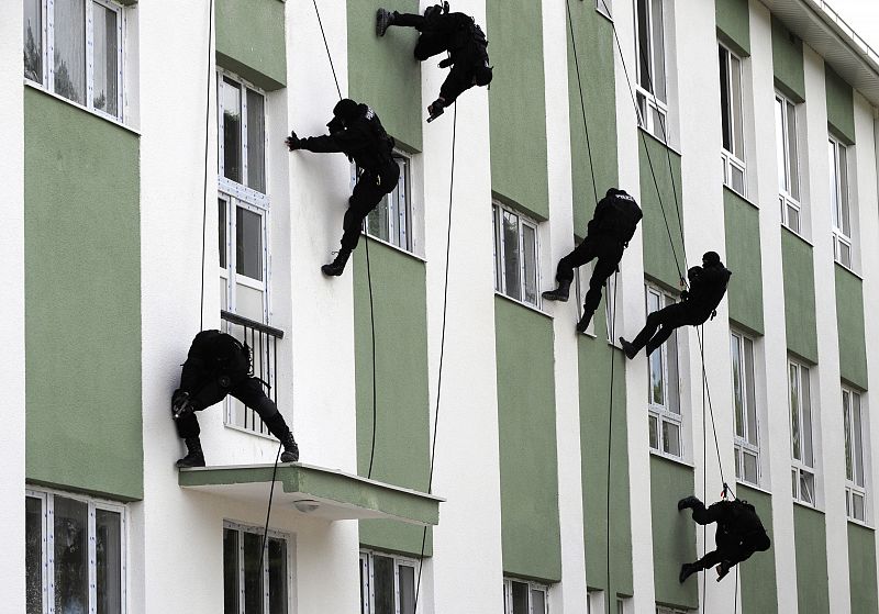 Special Forces policemen rappel down a building during a demonstration for Macedonian Police Day in Skopje