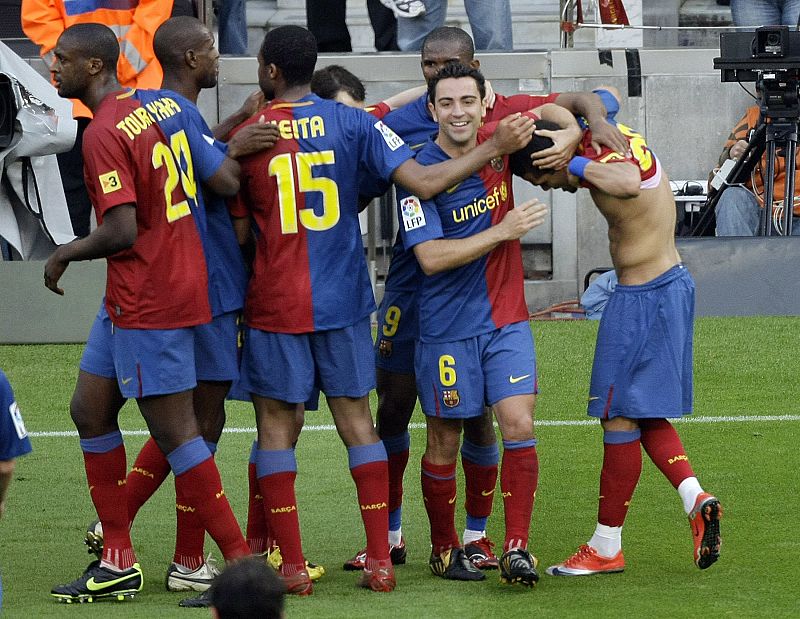 Barcelona's players celebrates Daniel Alves' goal against Villarreal during their Spanish First Division soccer match at Nou Camp stadium in Barcelona