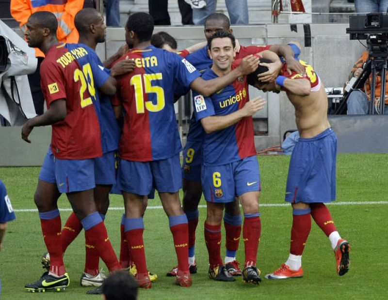 Barcelona's players celebrates Daniel Alves' goal against Villarreal during their Spanish First Division soccer match at Nou Camp stadium in Barcelona