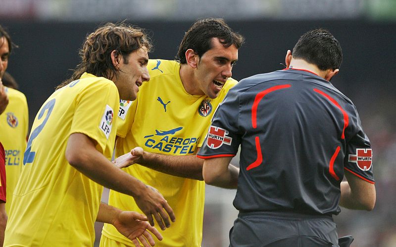 Gonzalo Rodríguez y Diego Godín protestan al árbitro del encuentro, Fernando Teixeira Vitienes.