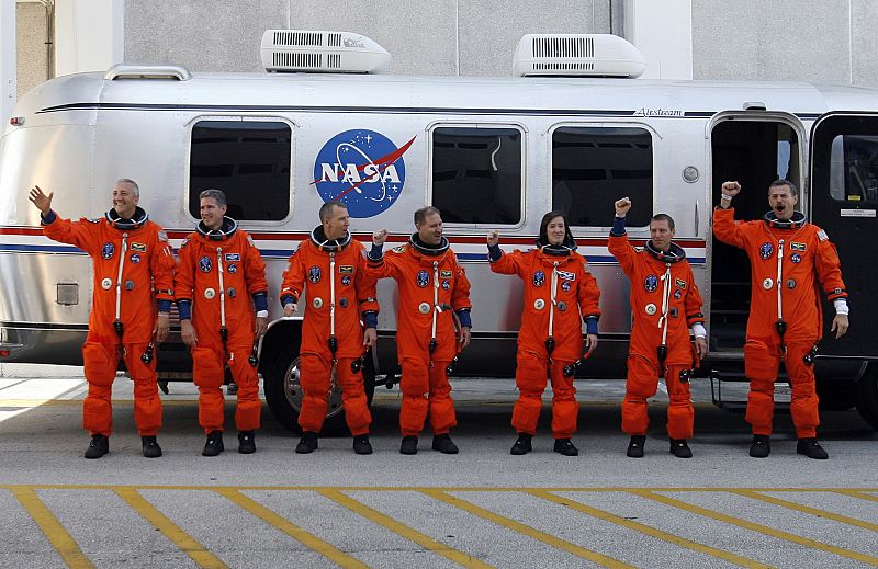 The crew of the space shuttle Atlantis poses before leaving crew quarters for launch pad 39A at the Kennedy Space Center in Cape Canaveral