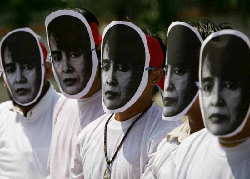 Activists wearing masks of Myanmar's opposition leader Aung San Suu Kyi protest outside the Chinese embassy in Bangkok