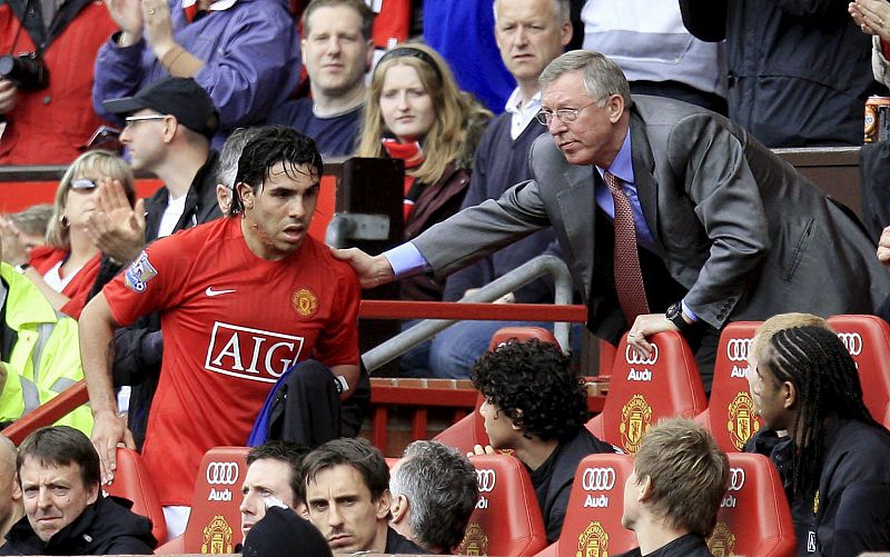 Carlos Tévez recibe la felicitación de Ferguson tras el partido. El argentino, que no tiene decidida su continuidad en el equipo, se emocionó.