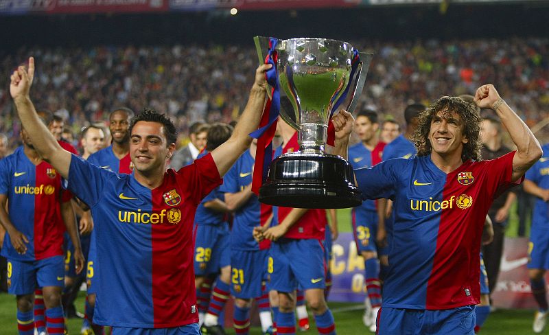 Barcelona's captains Hernandez and Puyol celebrate with their Spanish first division soccer league trophy in Barcelona