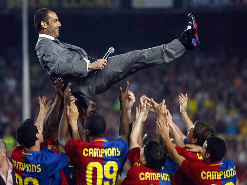 Barcelona's coach Guardiola is tossed by players during celebrations of Spanish first division soccer league win in Barcelona