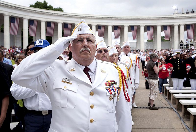 Veteranos de guerra saludan durante el himno nacional