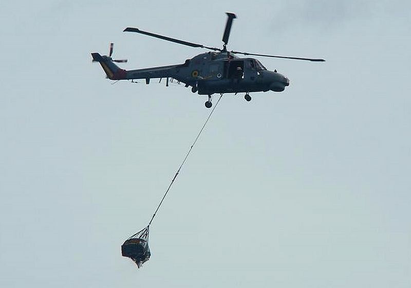 Un helicóptero brasileño transporta restos del avión a uno de los barcos que participan en la búsqueda.